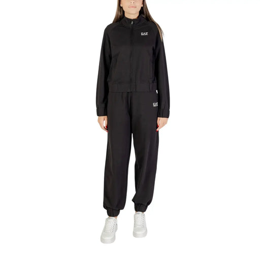 Women wearing a black full-zip tracksuit and white sneakers for activewear