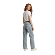 Light-wash denim jeans with classic five-pocket design and straight-leg cut paired with ea7 women white cotton sequin t shirt