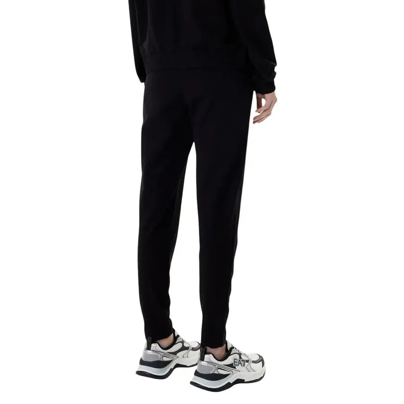 Ea7 women’s black hooded jumpsuit with pockets paired with black tapered jogger pants featuring a sleek modern fit