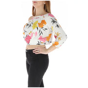Floral off the shoulder crop top in white with vibrant pink orange yellow floral patterns and black leaf accents