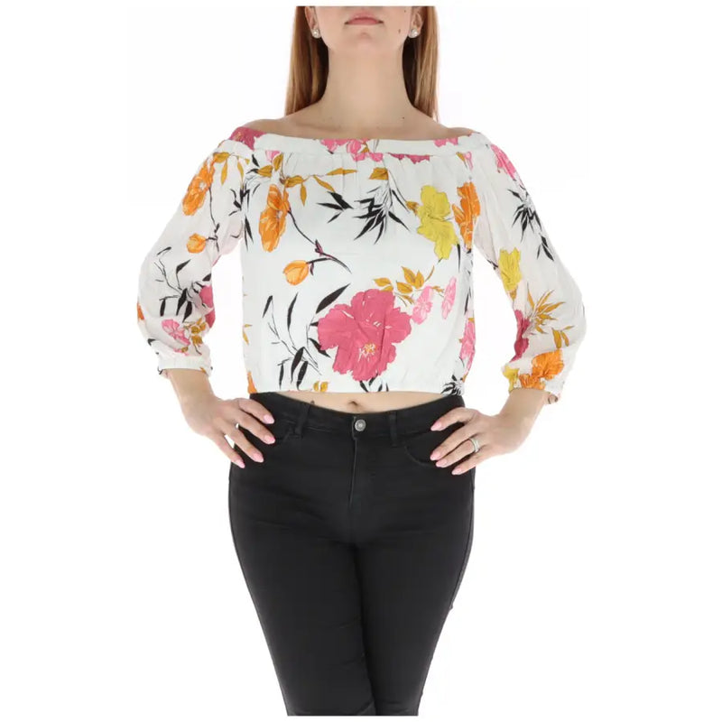 Floral off the shoulder crop top featuring a white blouse with vibrant pink orange and yellow floral print on flowing fabric