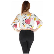 White floral off the shoulder crop top with vibrant pink yellow and orange print on flowing fabric
