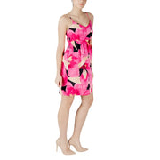 A vibrant fuchsia floral print sleeveless dress with black and cream accents and thin spaghetti straps