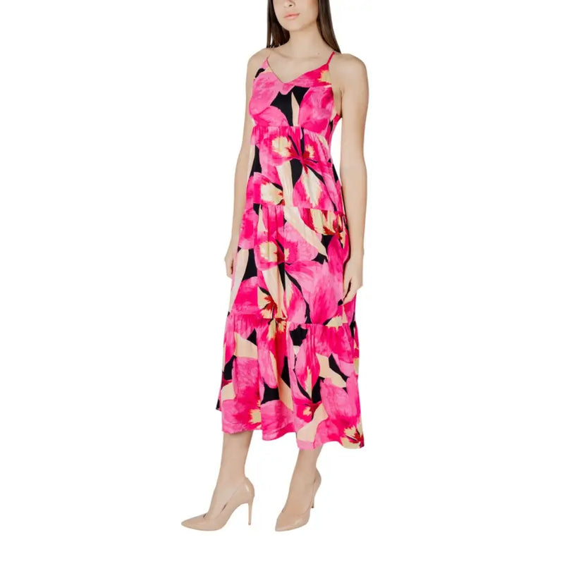 Fuchsia floral v-neck dress with straps featuring a vibrant pink floral maxi design with black and cream tiered skirt