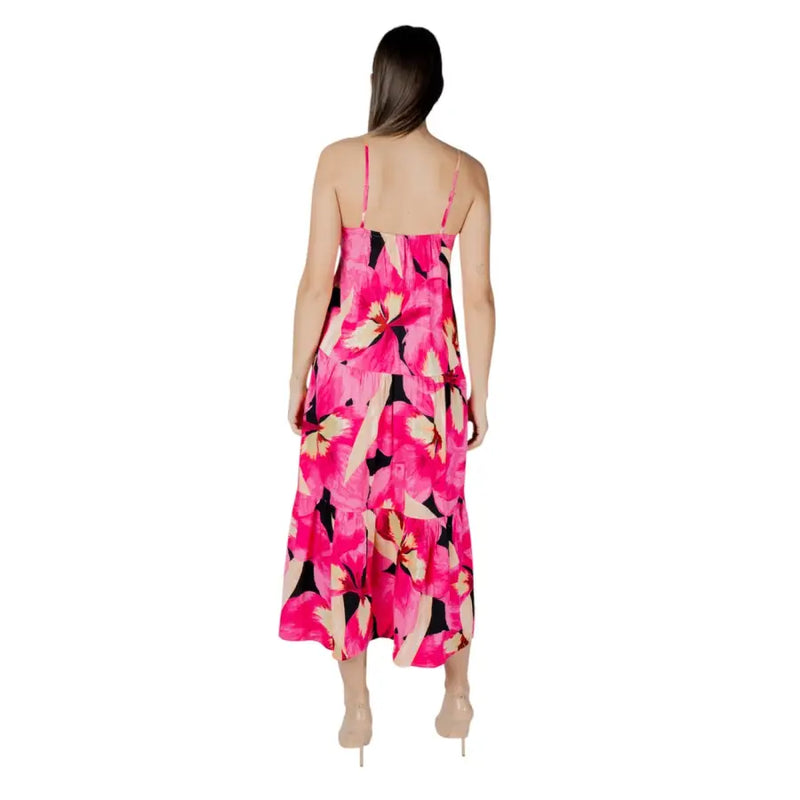 A vibrant fuchsia floral v-neck maxi dress with thin straps and tiered layers perfect for summer occasions