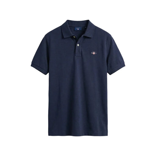 Navy blue Gant men polo shirt with buttoned collar short sleeve cotton pique and small embroidered logo on left chest