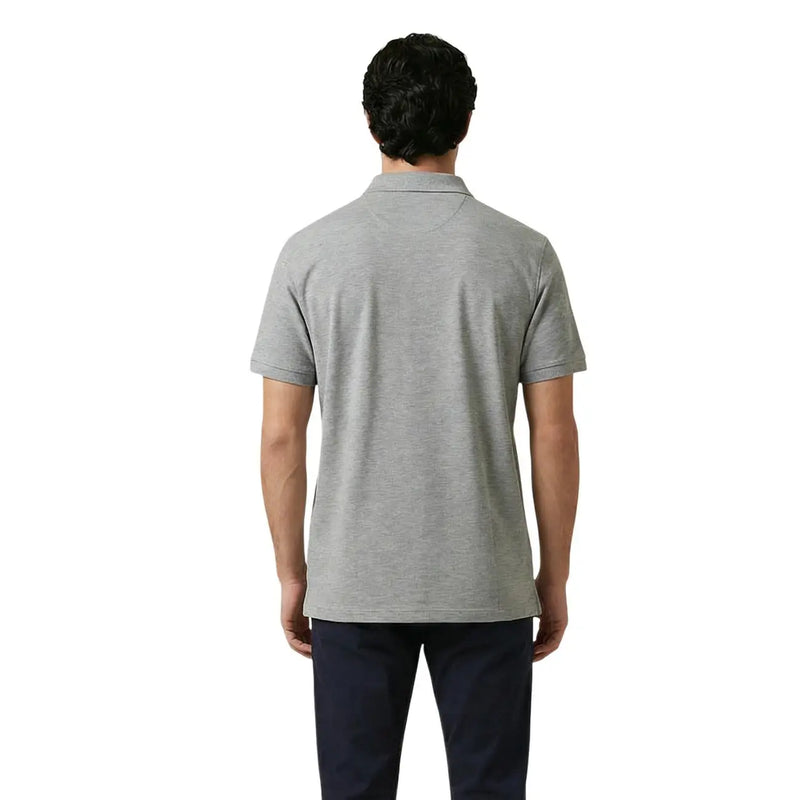 A man wearing a gant men polo shirt grey cotton stretch short sleeve with a classic collar and neatly stitched seams
