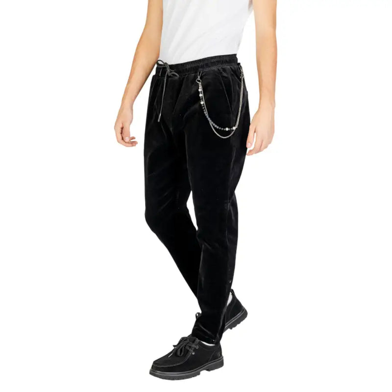 Men’s black velvet drawstring cargo trousers with silver wallet chain and black lace-up shoes