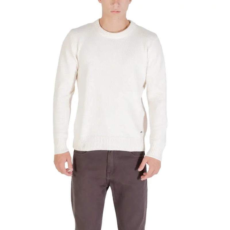Cream-colored crew-neck sweater with ribbed cuffs and hem, likely made of cotton or wool.