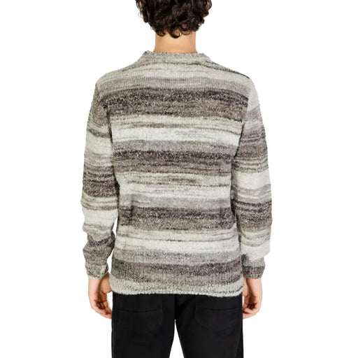 Striped sweater with a mix of gray and black colors, made from soft wool material.