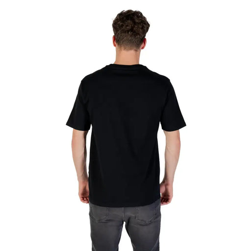 Men’s black printed short-sleeve cotton T-shirt paired with grey jeans displayed in product listing