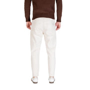 Cream-colored slim-fit denim trousers in white cotton with a clean back pocket design shown from the back by Gianni Lupo