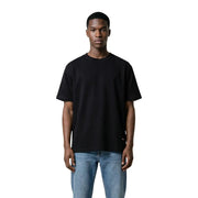Black oversized crewneck t-shirt with subtle brand tag made of 100% cotton by Gianni Lupo for men