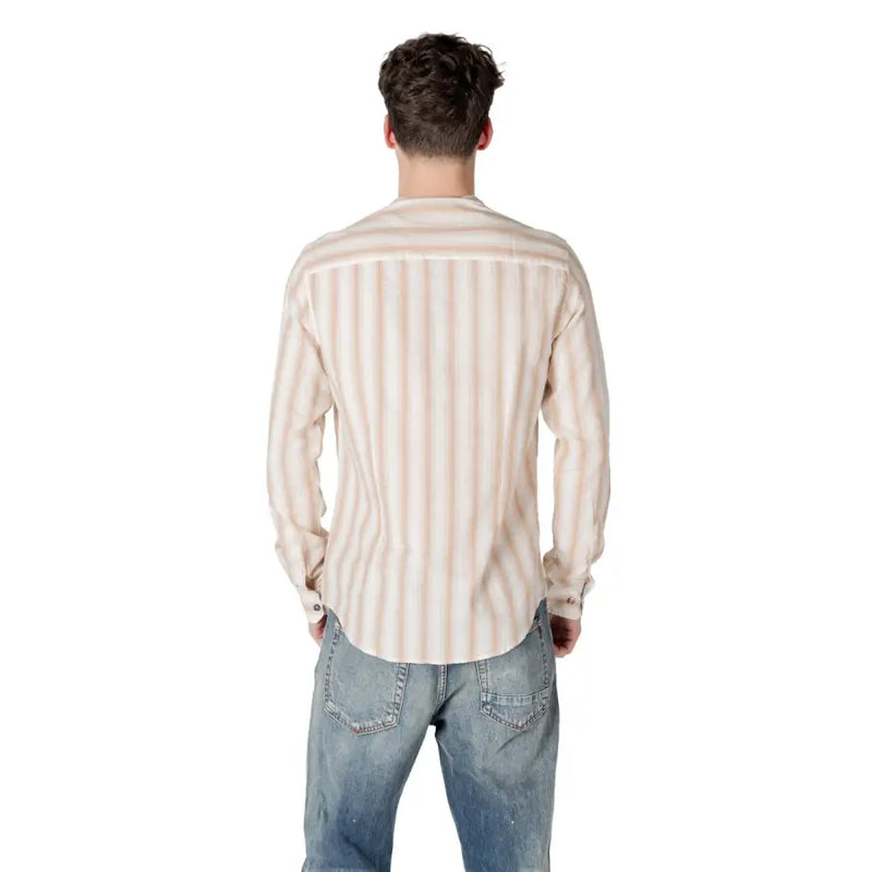 A man wearing a Gianni Lupo men’s beige striped long-sleeved button-down shirt in soft beige and cream tones