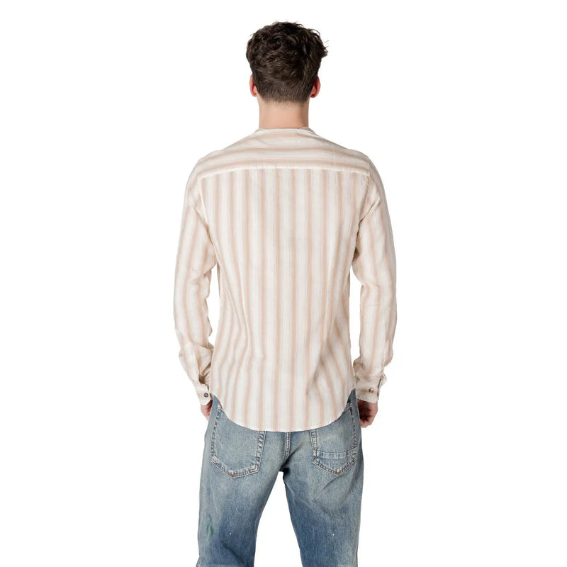 A man wearing a Gianni Lupo men’s beige striped long-sleeved button-down shirt in soft beige and cream tones
