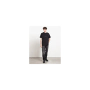 Schwarzes Kurzarmhemd t-shirt mit minimalistischem Brustlogo, kombiniert mit grauen Givenchy Herren-Baumwolljeans in Größe IT 44