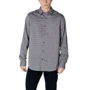 Gray patterned men’s long sleeved shirt made of fabric with a subtle repeating pattern of small dark symbols
