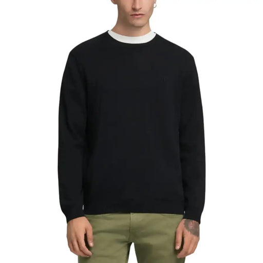 Black crew neck sweater with white collar and cuffs, likely made of cotton or a similar soft fabric.