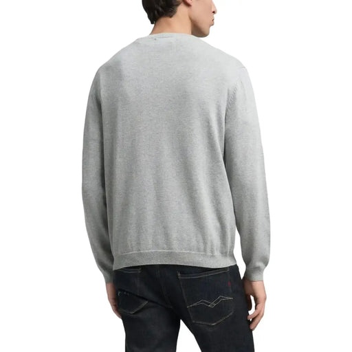 Heather gray crewneck sweater with pocket detail.