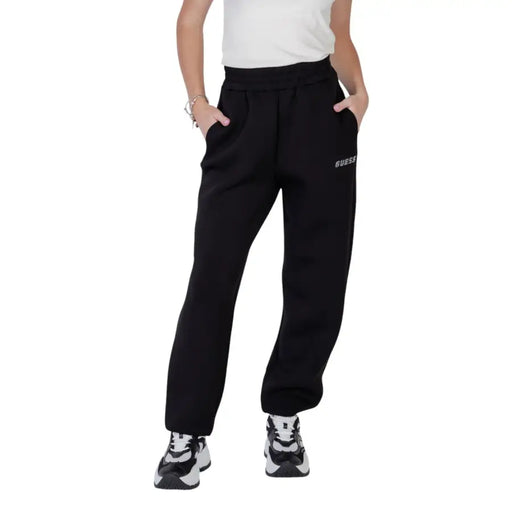 Black guess active women printed trousers with soft fleece material and subtle white logo on the left thigh