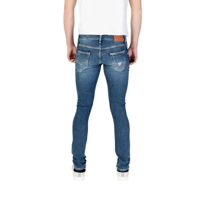Guess Men blue slim fit denim jeans with subtle fading and distressed details from spring summer collection