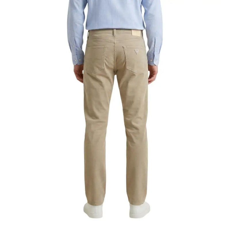 Beige guess Herrenhose aus Baumwollmischgewebe mit klassischem Fünf-Taschen-Design und dezentem Logo auf der Rückseite.