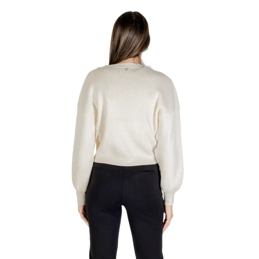 Woman wearing a cream ribbed long-sleeve sweater and black pants showcasing Guess Women Beige V Neck Long Cardigan