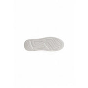 White rubber sole with embossed guess logo and wavy tread pattern on guess women black faux leather sporty sneakers