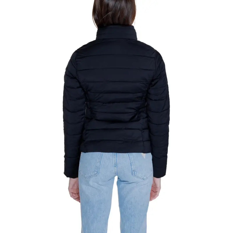 Woman wearing Guess Women Black Long Zip Front Pocket Jacket with light-wash jeans