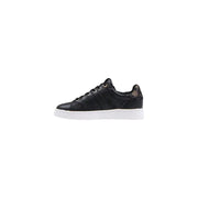 Back view of guess women black print slip on sneakers with subtle gold logo on polyurethane heel and white sole