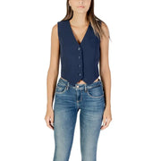 Woman wearing dark blue sleeveless V-neck button-up vest with blue jeans
