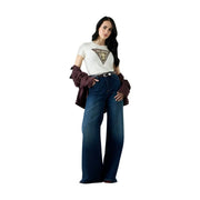 Woman wearing dark blue wide-leg jeans with a white Guess women cotton snake triangle round neck t shirt and maroon jacket