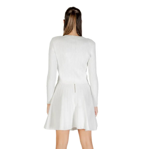 White ribbed long-sleeve top and flared mini skirt set displayed with Guess Women White Long Buttoned Round Neck Cardigan