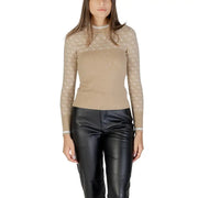 Women’s long-sleeve high-neck two-tone top with sheer patterned yoke paired with black leather-look trousers
