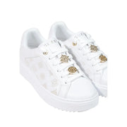 Guess women white polyurethane slip on sneakers with gold-toned embellished lace eyelets and subtle side logo pattern