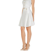 White sleeveless crop top and A-line mini skirt with gold buttons for fall winter fashion