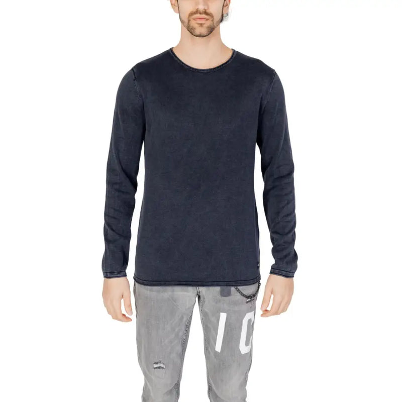 Dark navy long-sleeved cotton knit pullover with subtle texture and brand tag at hem by Jack and Jones for men