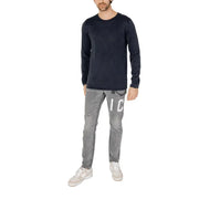 Dark navy long-sleeved cotton knit pullover with subtle texture and small jack & jones brand tag at the hem