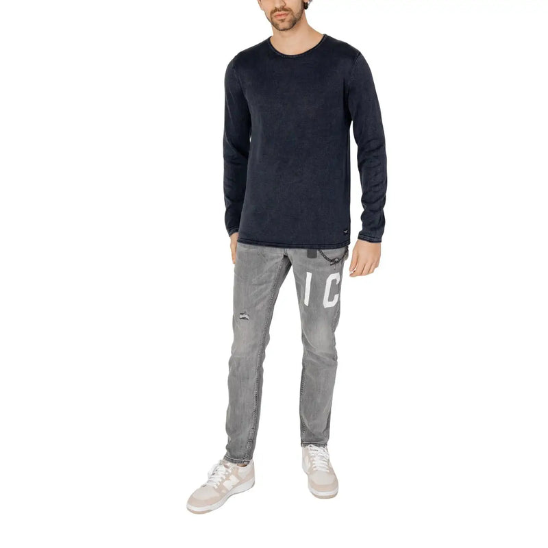 Dark navy long-sleeved cotton knit pullover with subtle texture and small jack & jones brand tag at the hem