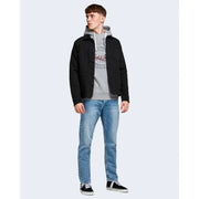 Black button-up jacket with hood and front pockets paired with jack and jones men blue jeans in 100% cotton
