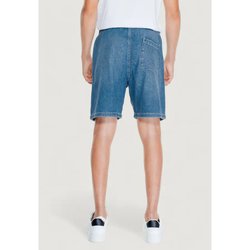 Blue denim cotton shorts for men by jack & jones featuring a classic back pocket and straight hem shown from the back