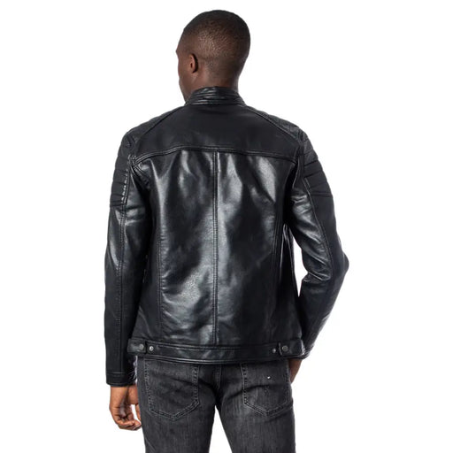 Men’s black faux leather biker jacket with ribbed details paired with dark wash jeans