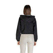 Black hooded windbreaker jacket worn by a woman with light-colored pants in Jacqueline De Yong product image