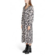 A woman wears a Jacqueline De Yong grey leopard long sleeve v neck midi dress with black and beige print