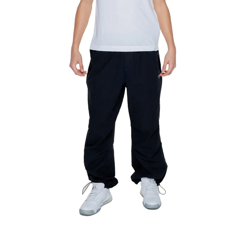 Karl kani mens black plain trousers 100 percent cotton with drawstring cuffs and side pockets front view