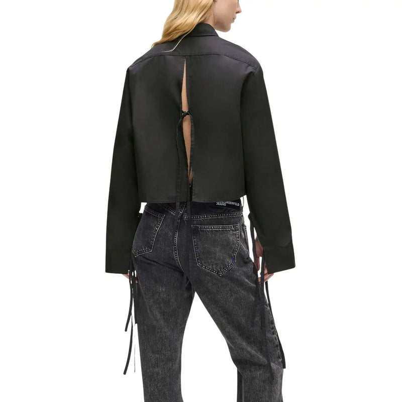 Back view of a black satin-like cropped jacket with back slit and side ties from Karl Lagerfeld Jeans women black organic cotton long shirt collection