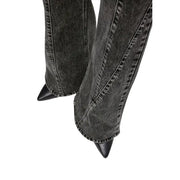 Karl Lagerfeld women’s black cotton jeans paired with black denim boots featuring pointed toes and stitching details
