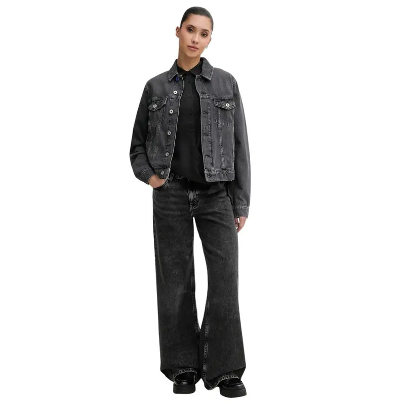 Dark gray denim jacket with classic button closures and flap pockets paired with karl lagerfeld black organic cotton jeans