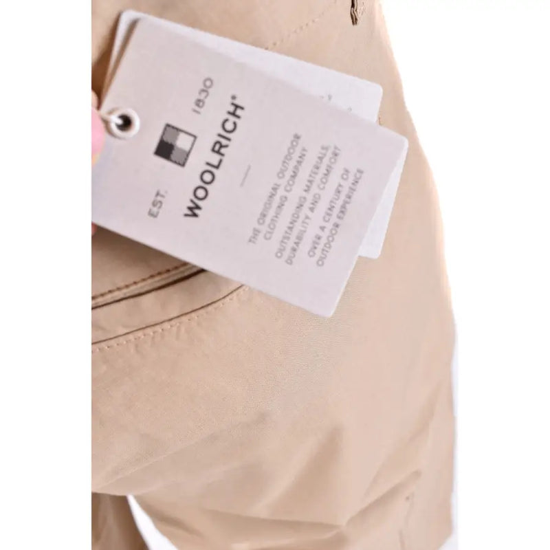 Beige woolrich khaki cargo shorts made of wool with a tag showing the original outdoor clothing company