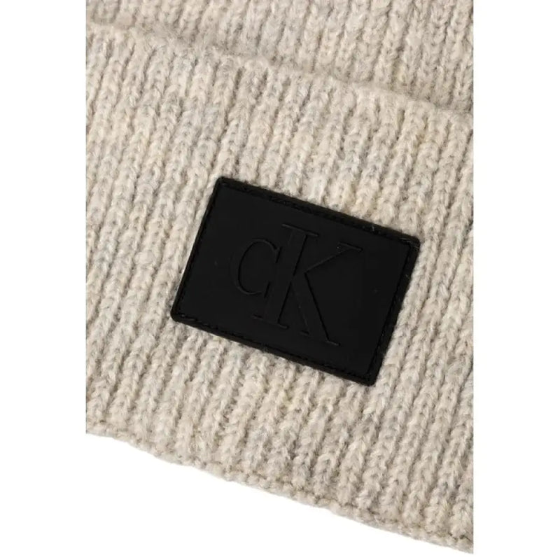 Beige Knit Beanie featuring a stylish black logo patch for fashionable winter wear